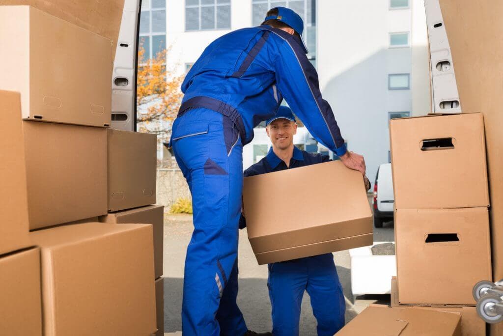 Movers carrying sofa outside